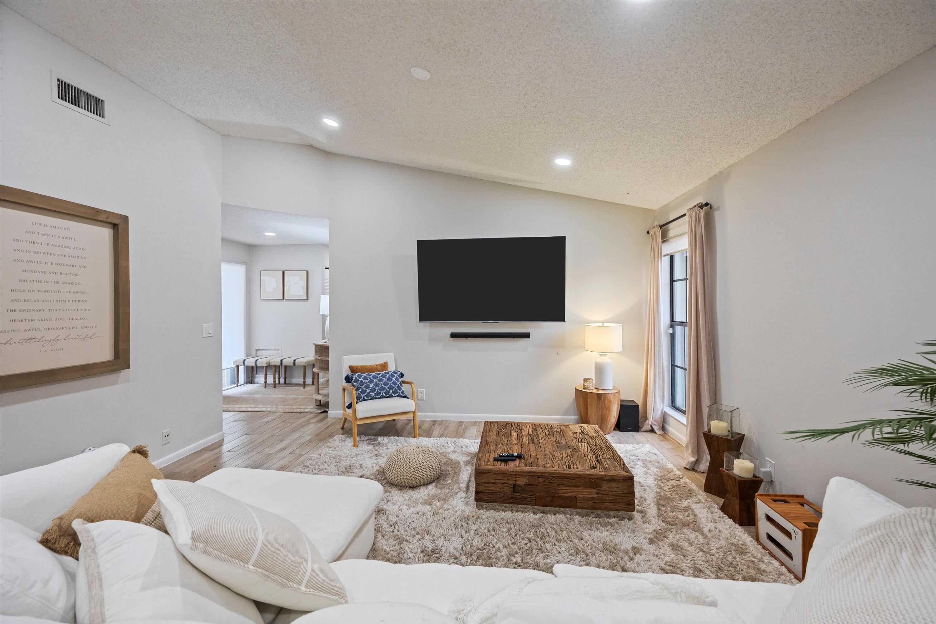 1769 Harborside Circle Wellington, FL 33414 - Photo 5 of 34 a living room with furniture and a flat screen tv