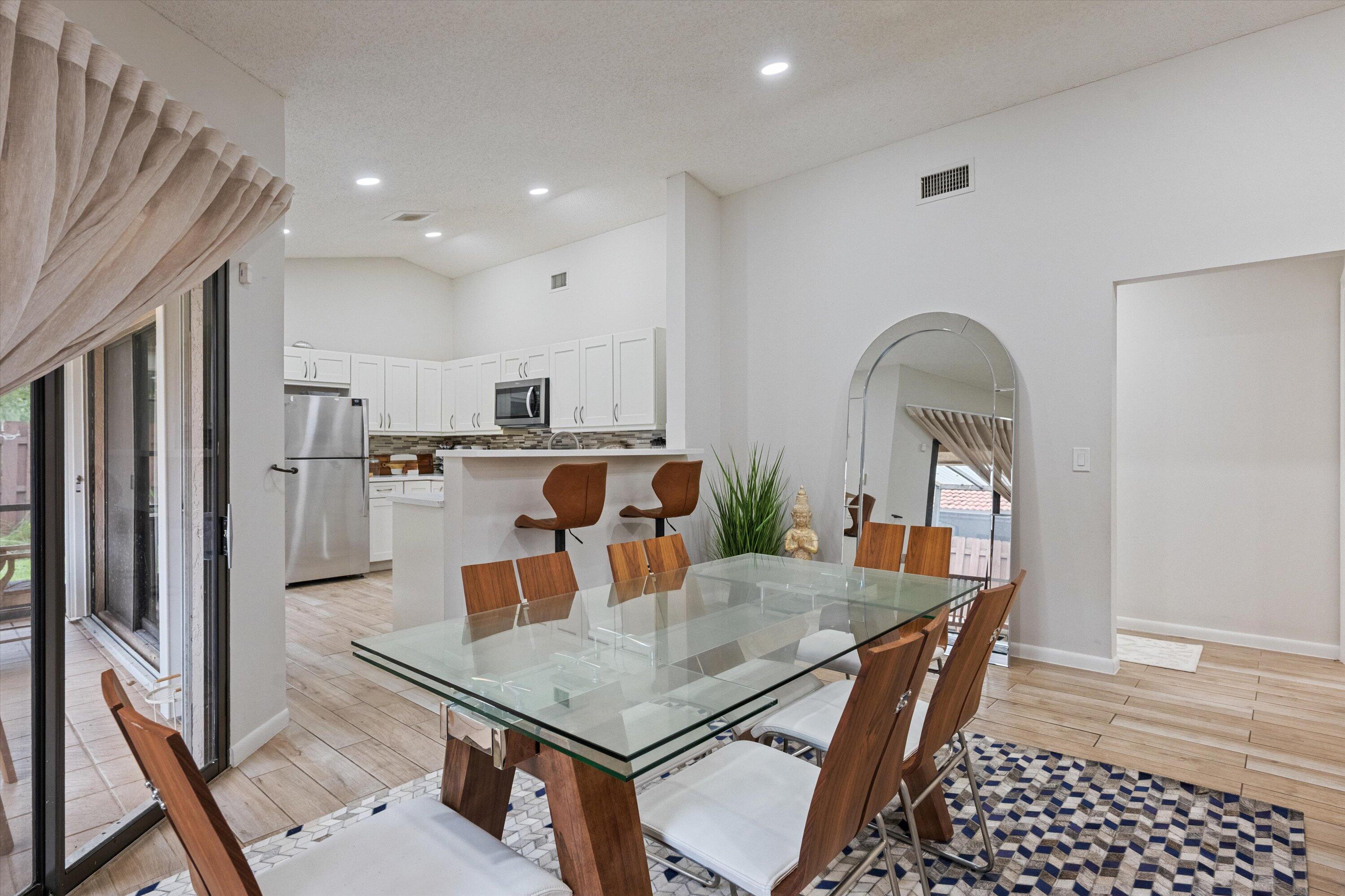 1769 Harborside Circle Wellington, FL 33414 - Photo 8 of 34 a dining room with furniture and wooden floor