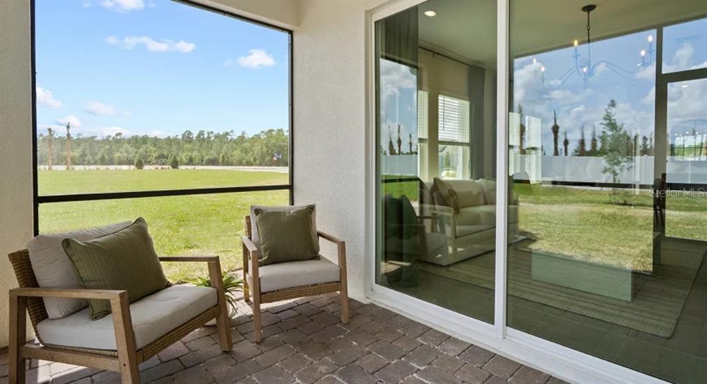 4246 St Thomas Way Kissimmee, FL 34758 - Photo 15 of 16 a balcony with furniture and view of the glass door