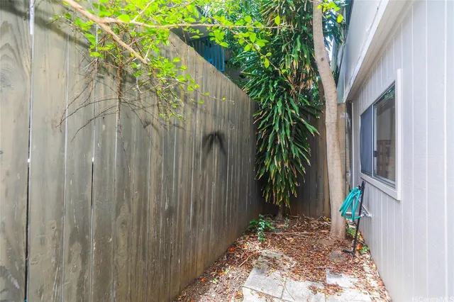 a view of a wooden door with a tree in the background