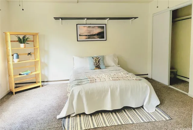 a bedroom with a bed and painting on the wall
