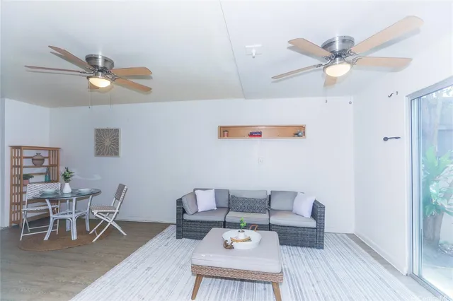 a workspace with furniture and a chandelier fan
