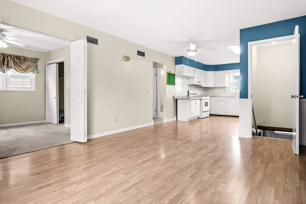a view of kitchen with cabinets and wooden floor