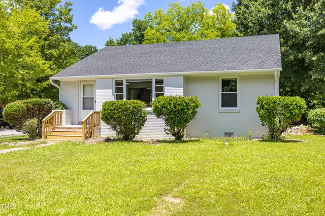 a view of a house with a yard and plants