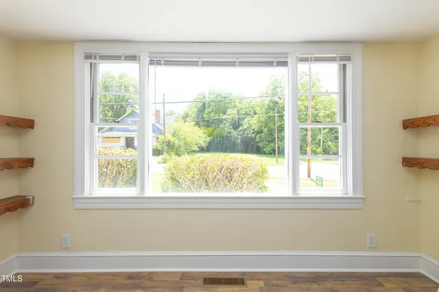 a view of a room that has a bed and a window