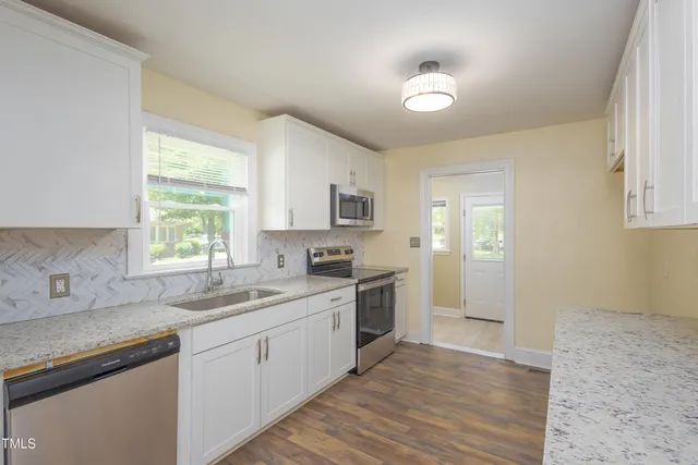 a kitchen with a sink cabinets and window