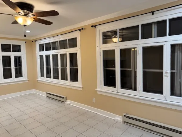 a view of a balcony with a ceiling fan and window