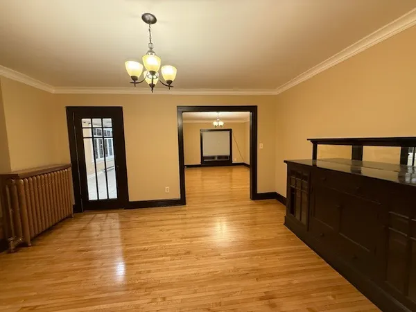 a dining room with wooden floor chandelier and wooden floor