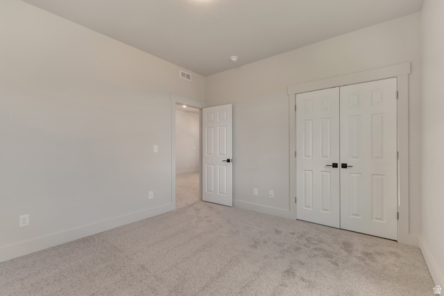 2535 West Santa Fe Drive Mapleton, UT 84664 - Photo 17 of 26 Unfurnished bedroom featuring light colored carpet and a closet
