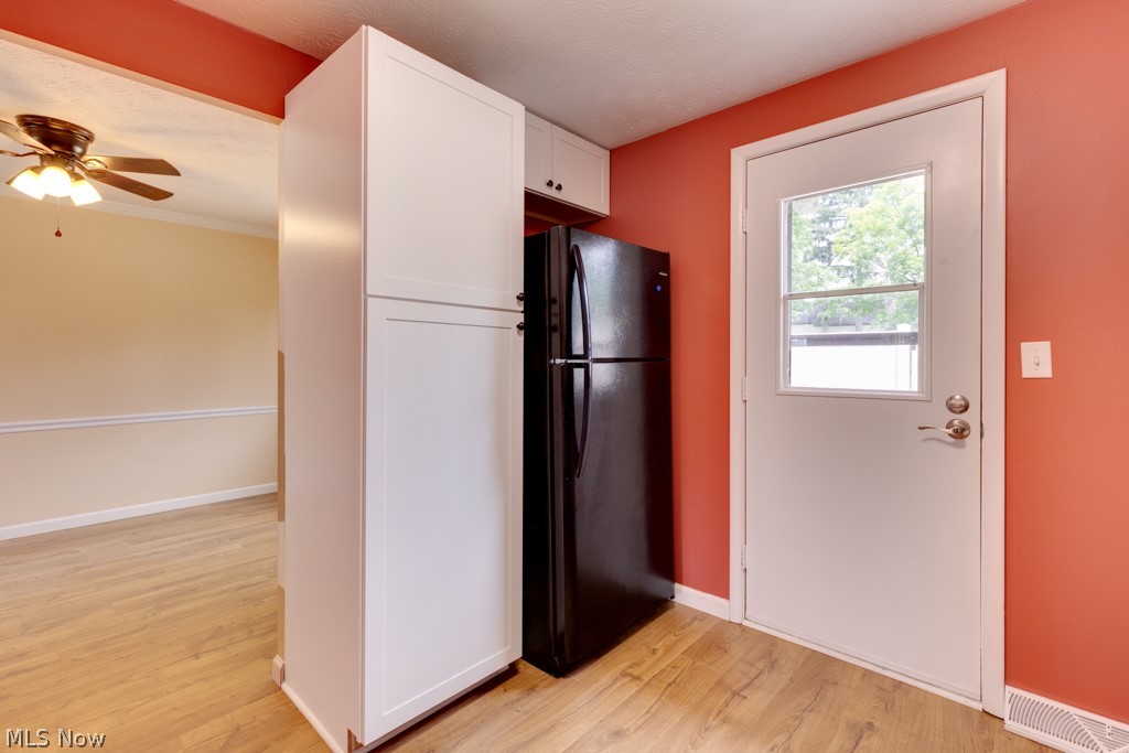 960 Hampton Ridge Drive Akron, OH 44313 - Photo 9 of 22 View of pantry, fridge and door to private patio