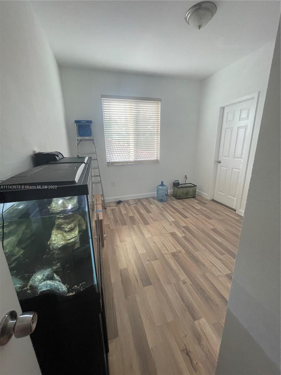 23744 Southwest 108th Court Homestead, FL 33032 - Photo 13 of 22 a bedroom with a bed and a window