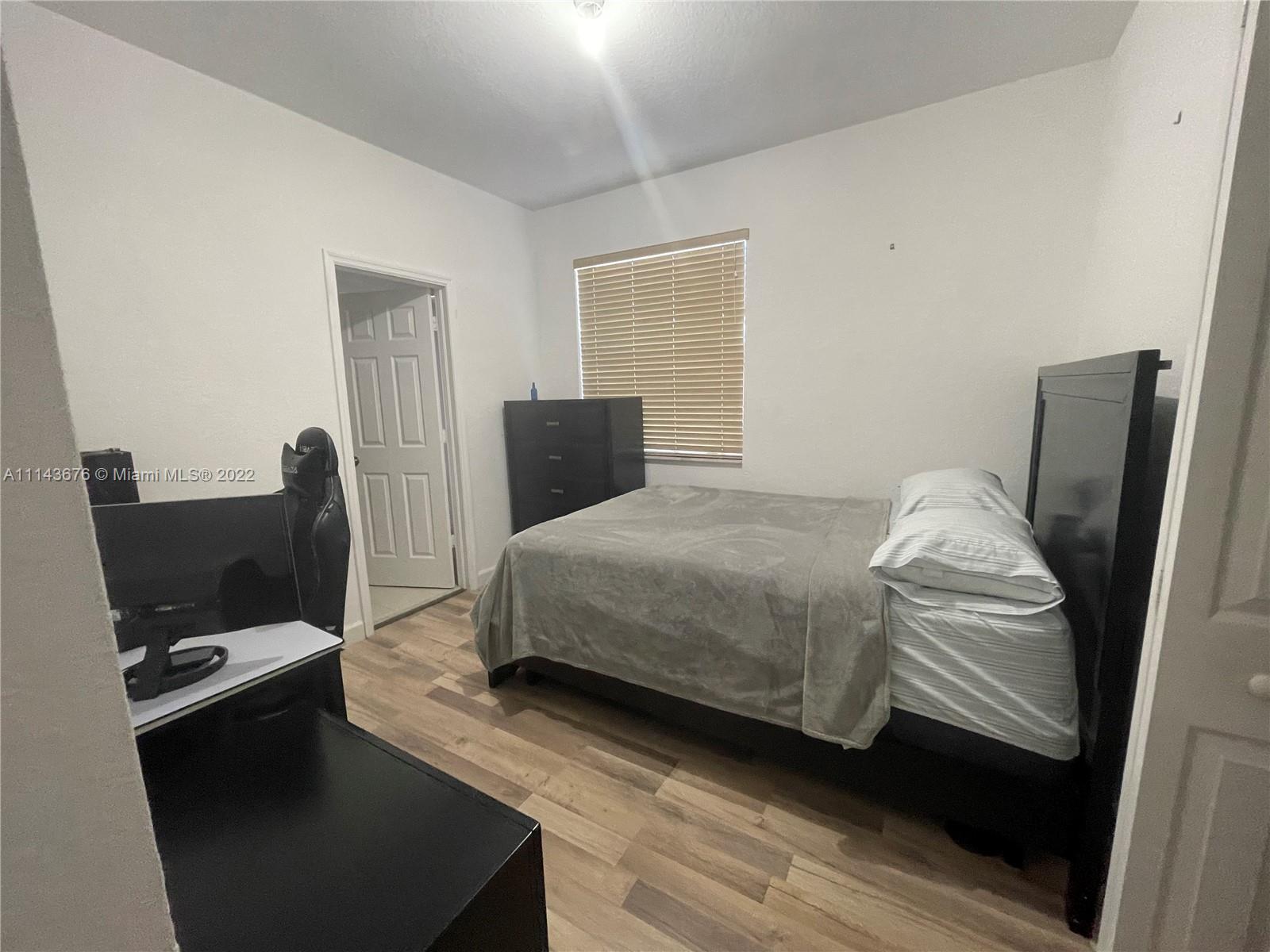 23744 Southwest 108th Court Homestead, FL 33032 - Photo 14 of 22 a bedroom with a bed and a television