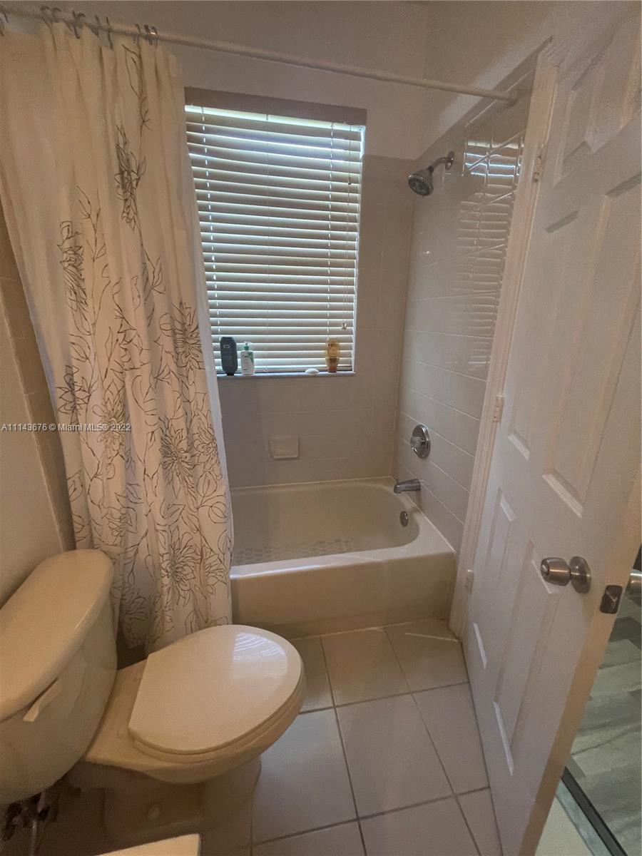 23744 Southwest 108th Court Homestead, FL 33032 - Photo 17 of 22 a bathroom with a toilet and a bathtub