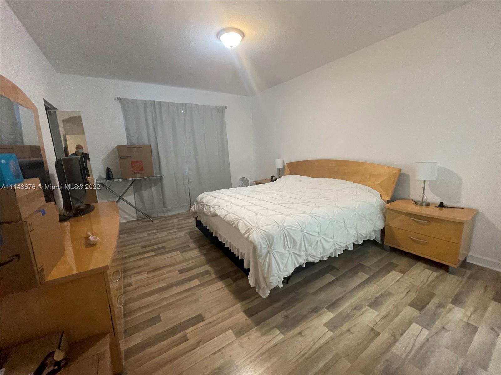 23744 Southwest 108th Court Homestead, FL 33032 - Photo 18 of 22 a bedroom with a bed a couch and dresser