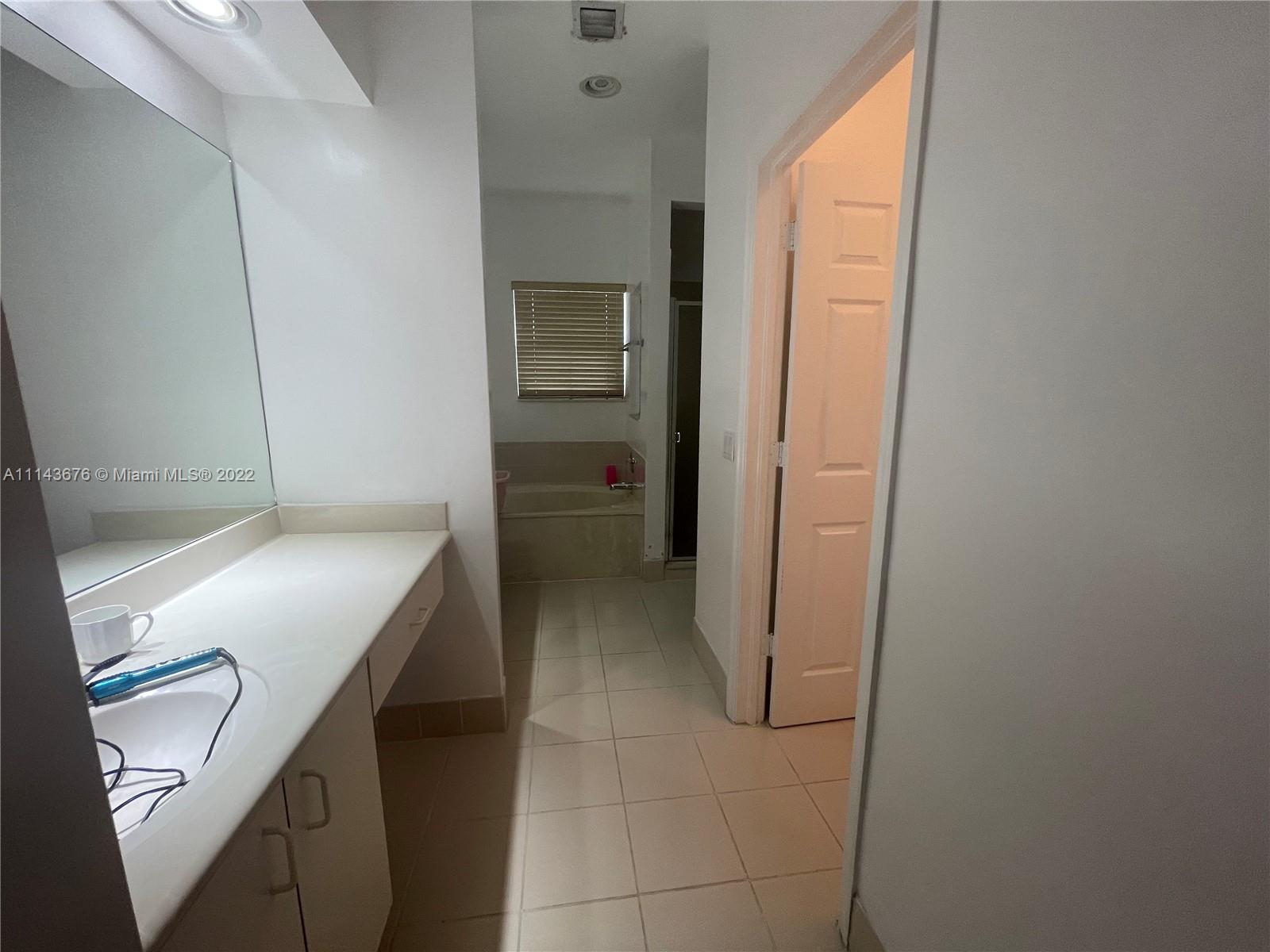 23744 Southwest 108th Court Homestead, FL 33032 - Photo 20 of 22 a kitchen with a refrigerator and cabinets