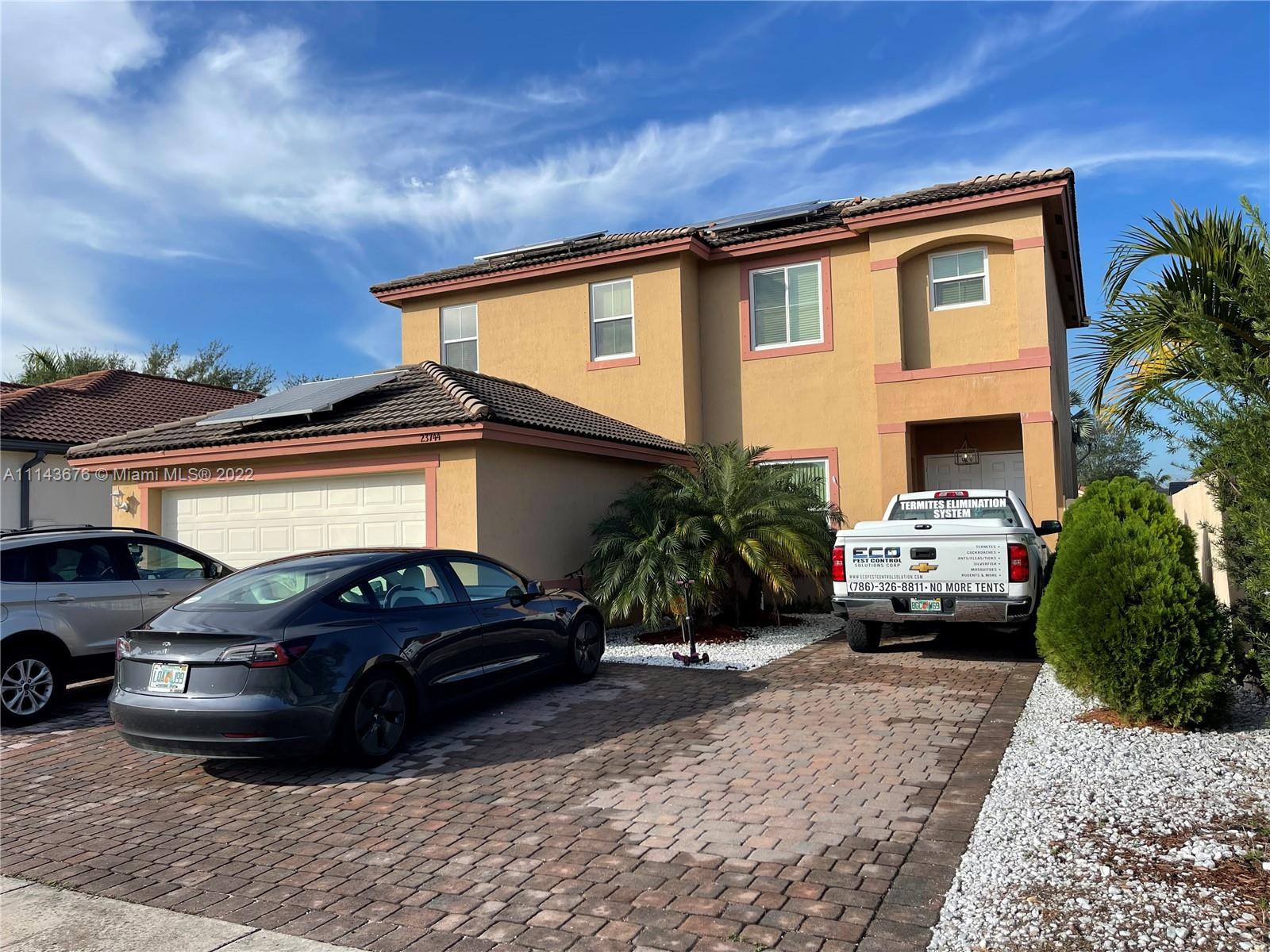 23744 Southwest 108th Court Homestead, FL 33032 - Photo 2 of 22 a front view of a house with a yard