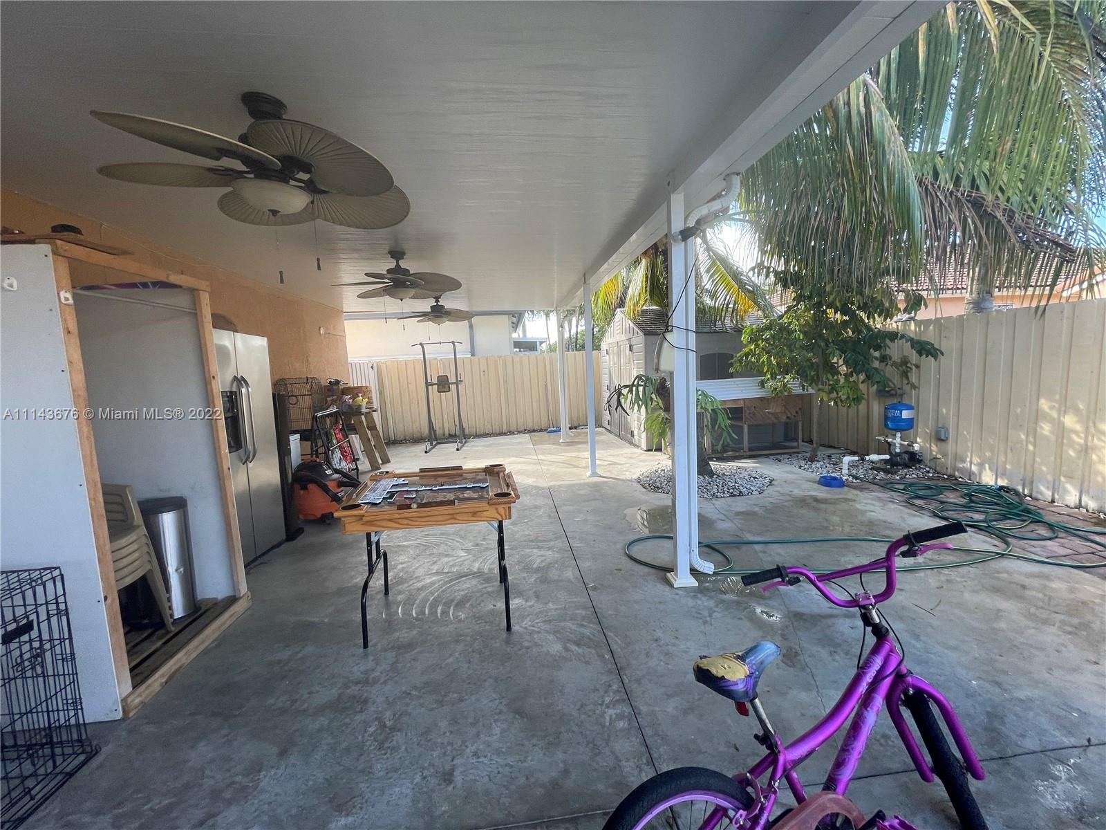 23744 Southwest 108th Court Homestead, FL 33032 - Photo 21 of 22 a living room with lots of furniture and a fireplace