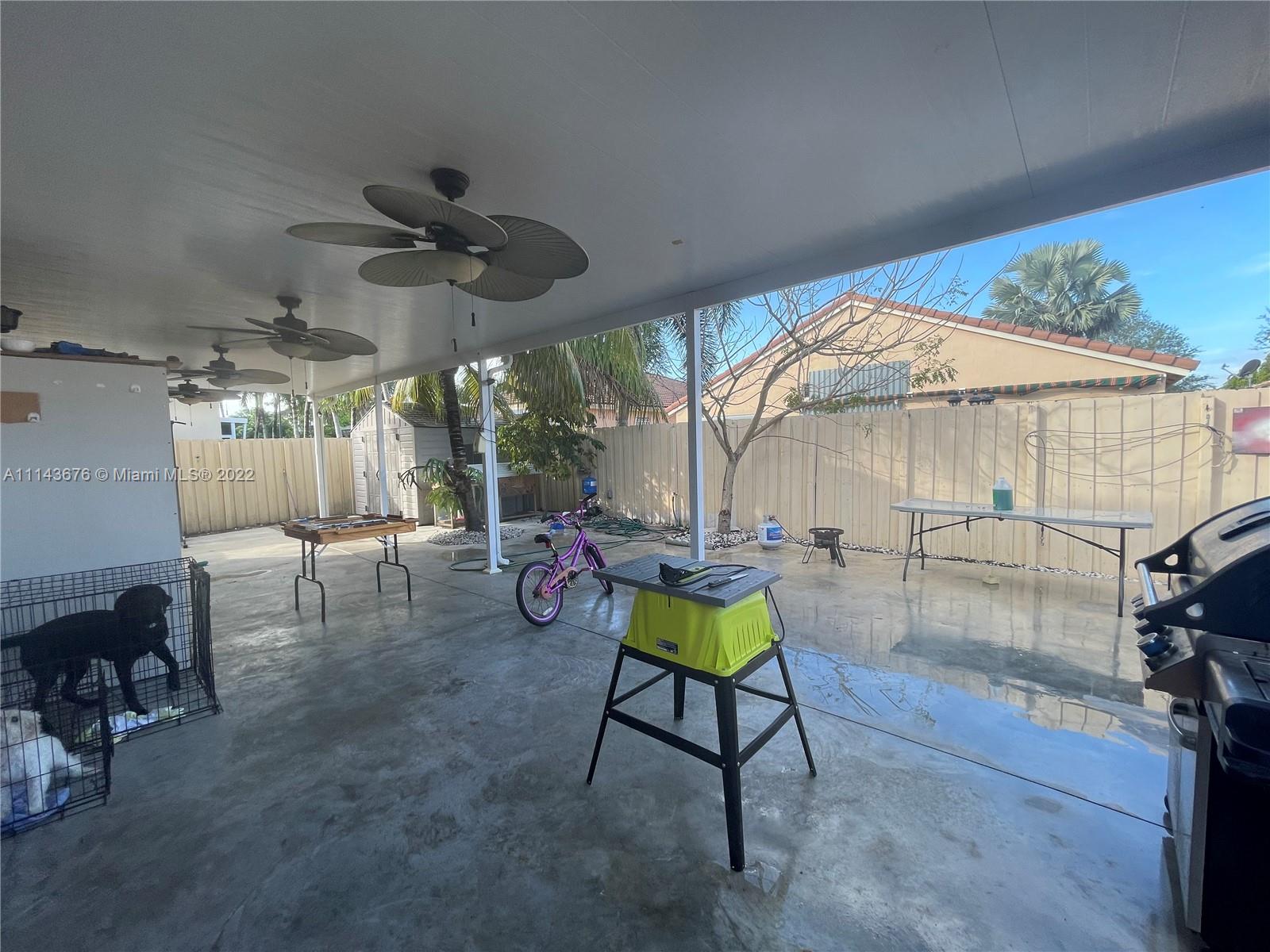 23744 Southwest 108th Court Homestead, FL 33032 - Photo 22 of 22 a room with lots of furniture and white walls