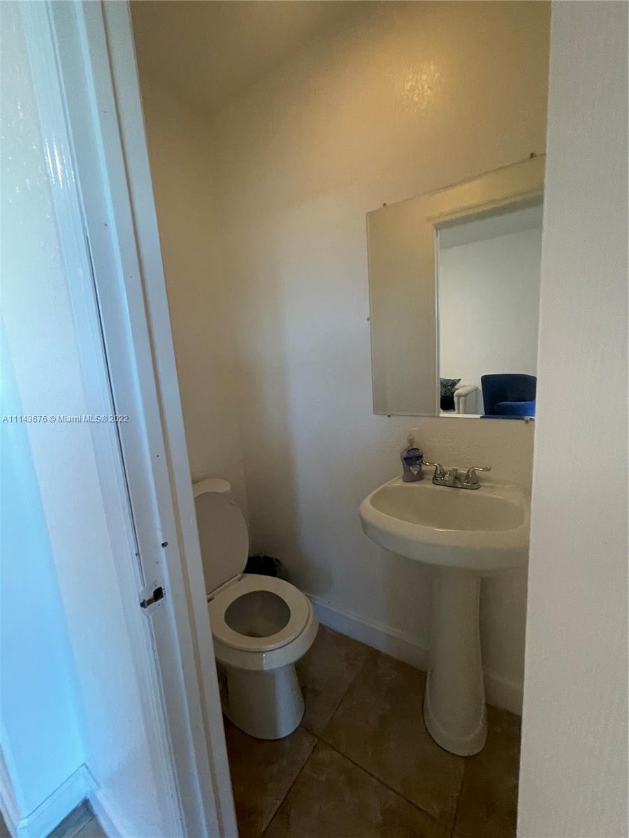 23744 Southwest 108th Court Homestead, FL 33032 - Photo 10 of 22 a bathroom with a sink and a toilet