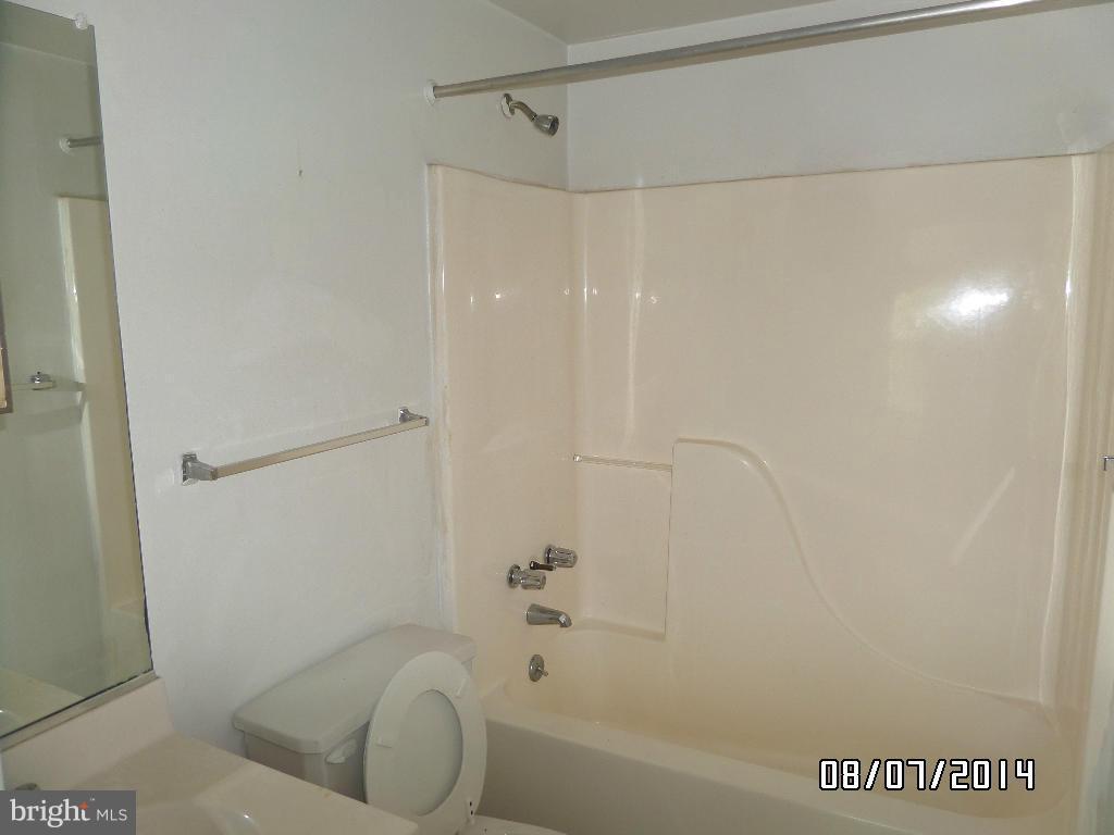 1363 Spelman Road Baltimore, MD 21225 - Photo 14 of 16 a bathroom with a bathtub and a shower