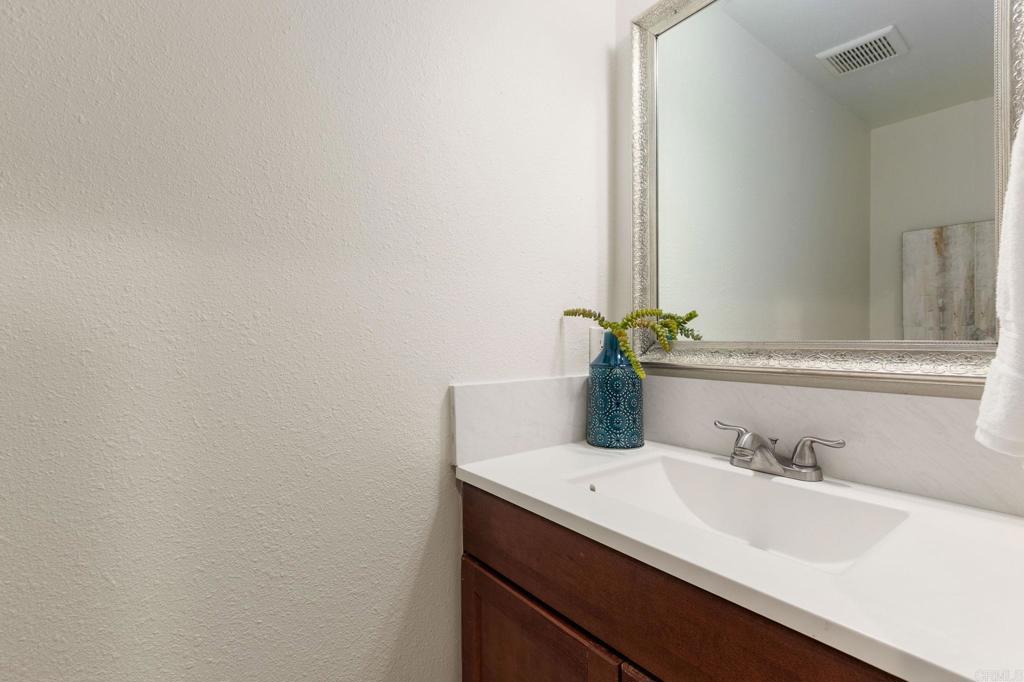 2992 Brandon Circle Carlsbad, CA 92010 - Photo 18 of 69 a bathroom with a sink and a mirror