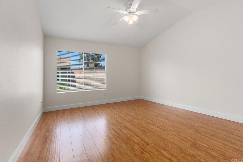 2992 Brandon Circle Carlsbad, CA 92010 - Photo 26 of 69 a view of an empty room with wooden floor and a window