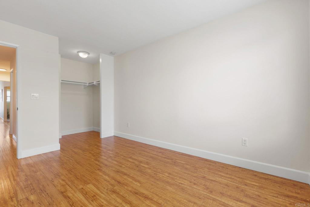 2992 Brandon Circle Carlsbad, CA 92010 - Photo 31 of 69 a view of an empty room with wooden floor and a window