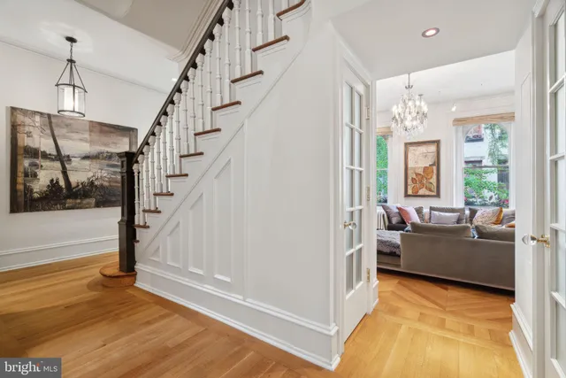 a view of staircase with wooden floor and book shelf