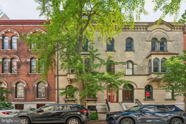 a front view of a building with parking