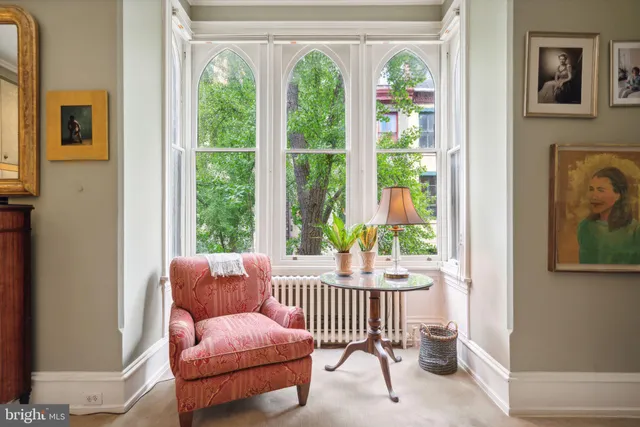 a view of a hallway with wooden floor and stairs