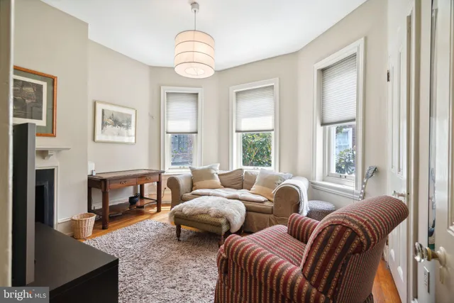 a bathroom with a sink a mirror and a painting on the wall
