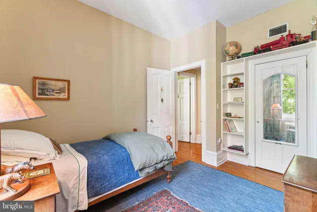 a bed sitting in a bedroom next to a window