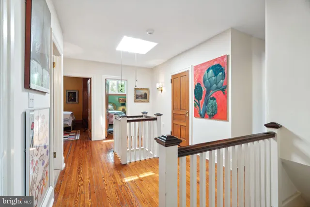 a bedroom with two beds and painting on the wall