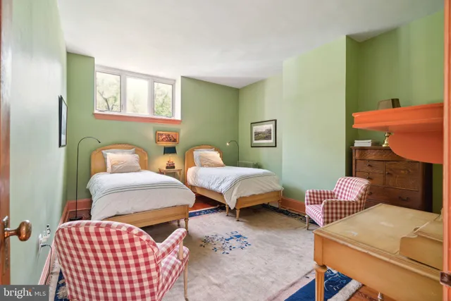 a living room with furniture a rug and a table