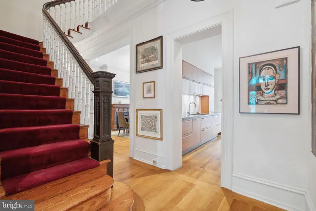 a view of a hallway with wooden floor and entryway