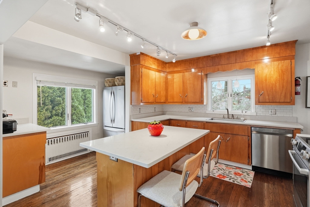 17 Vogel Street Boston, MA 02132 - Photo 11 of 43 a kitchen with a table chairs sink and wooden floor