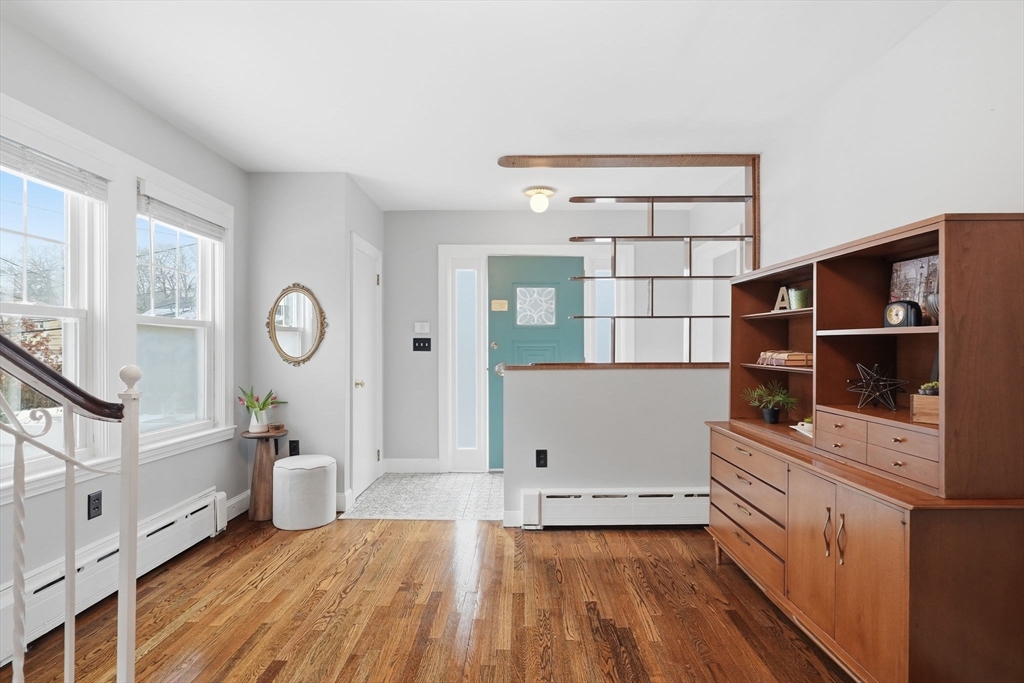 17 Vogel Street Boston, MA 02132 - Photo 15 of 43 a kitchen with a wooden floor and white cabinets