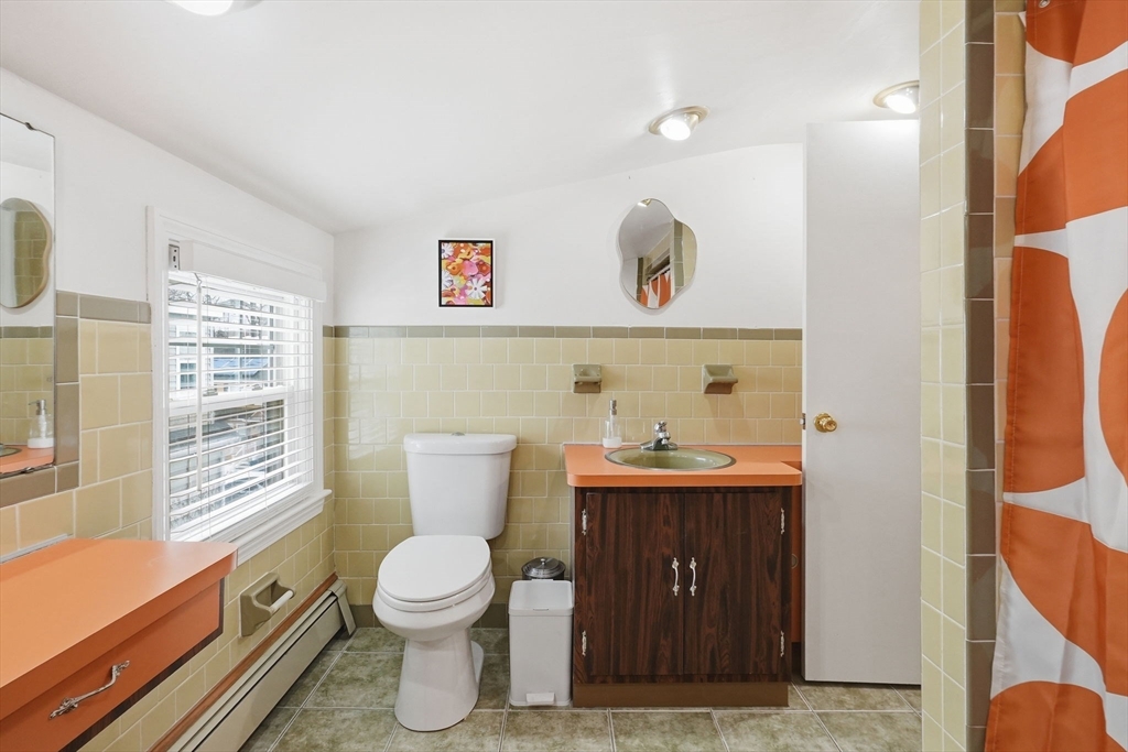 17 Vogel Street Boston, MA 02132 - Photo 34 of 43 a bathroom with a toilet a sink and mirror