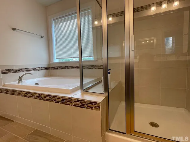 a bathroom with a bathtub and a shower