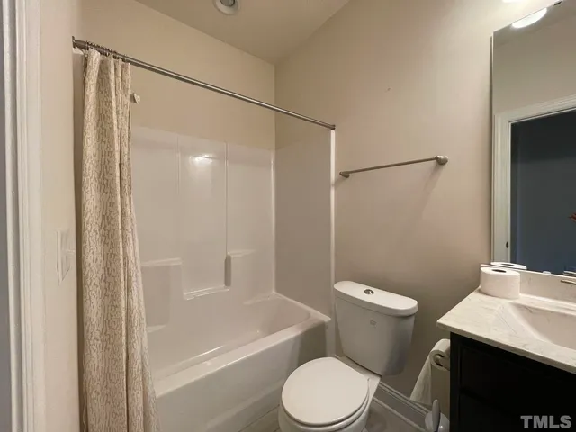 a white toilet sitting next to a bath tub