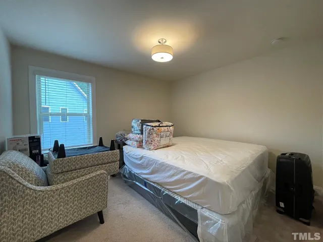 a bedroom with bed and a couch