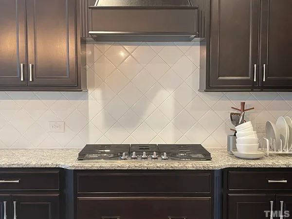 a view of room with granite countertop cabinets and a stove