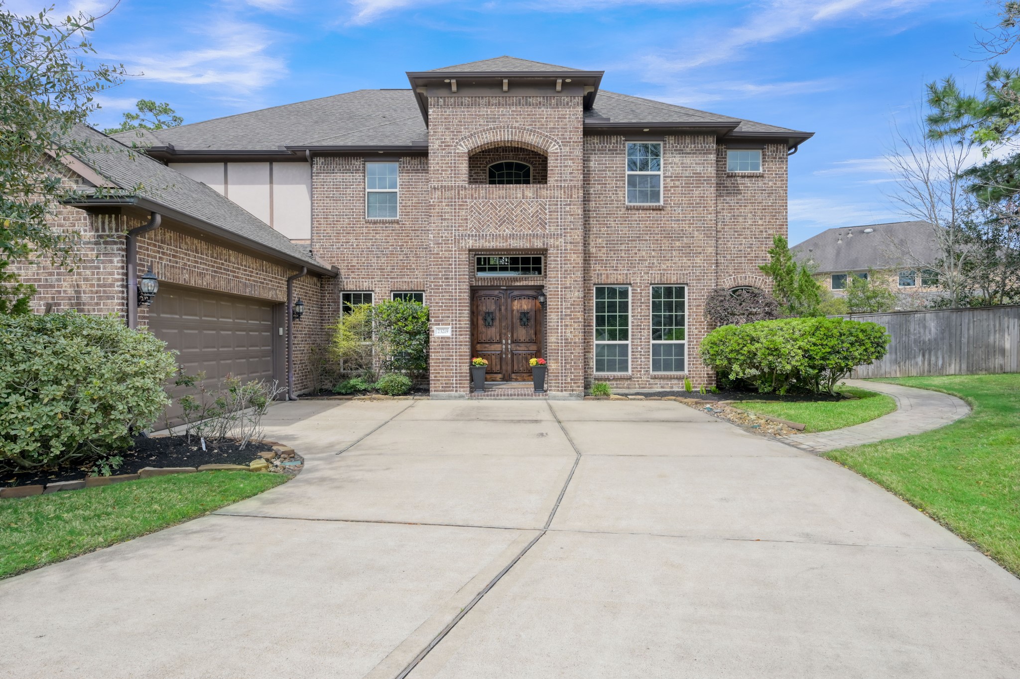 23219 Belted Kingfisher Trail Spring, TX 77389 - Photo 42 of 43 a front view of a house with a garden and plants