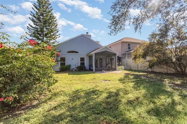 a front view of house with yard and trees around