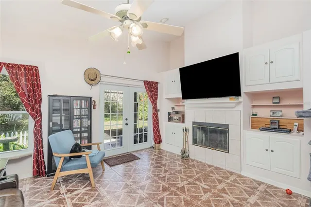 a living room with furniture a flat screen tv and a fireplace