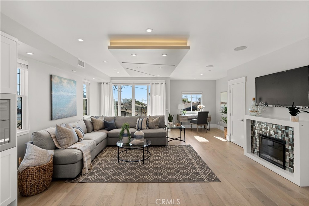 16760 A Bayview Drive Sunset Beach, CA 90742 - Photo 13 of 53 a living room with furniture a flat screen tv and a fireplace