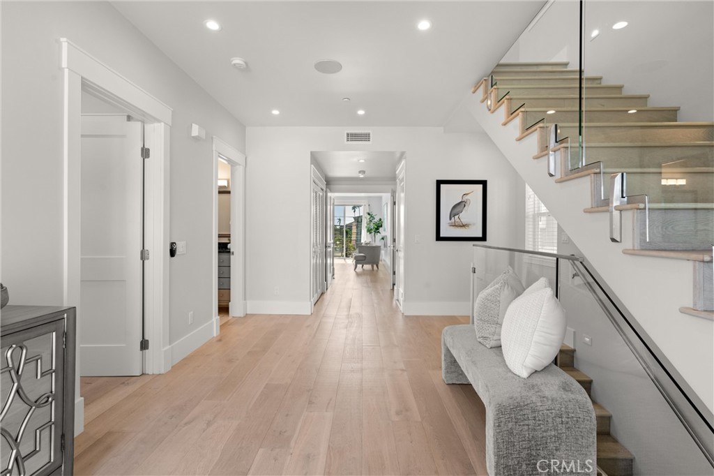 16760 A Bayview Drive Sunset Beach, CA 90742 - Photo 23 of 53 a hallway with a couch and chandelier