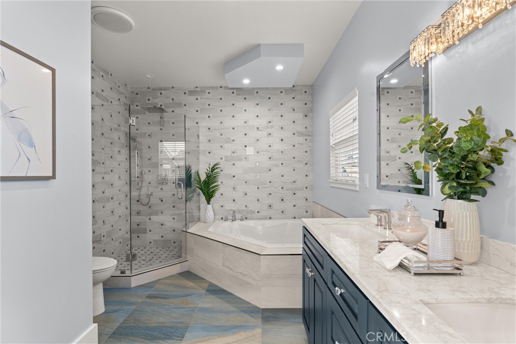 16760 A Bayview Drive Sunset Beach, CA 90742 - Photo 30 of 53 a bathroom with a granite countertop sink a mirror and a shower