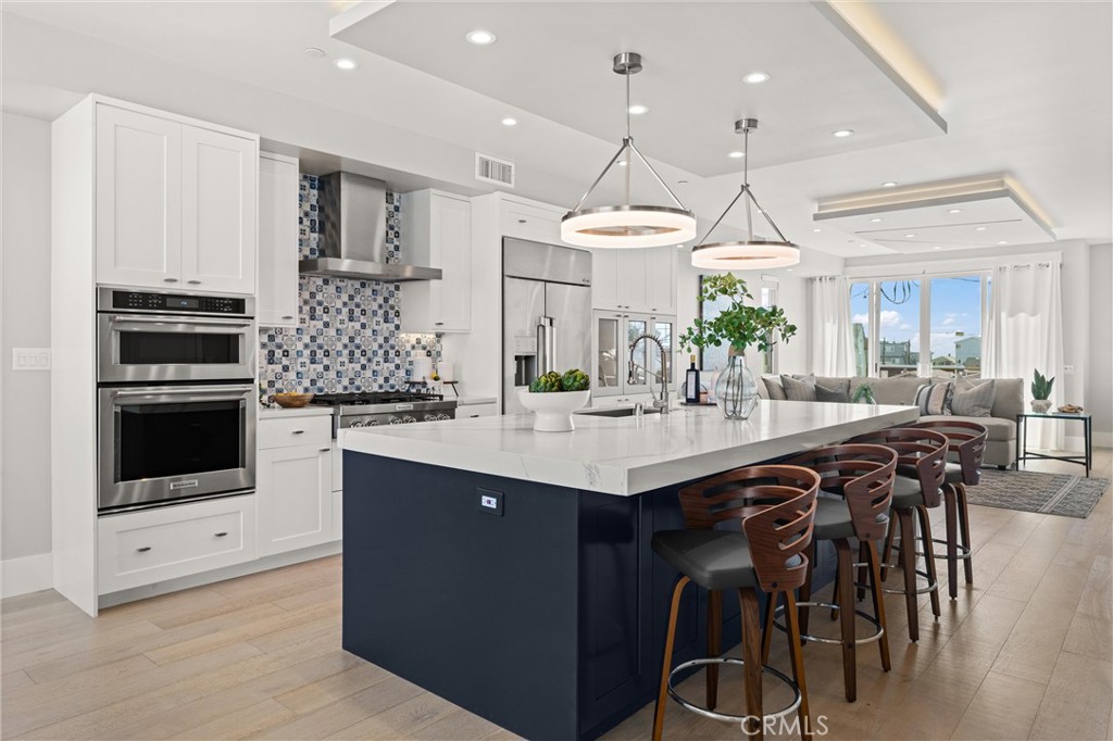 16760 A Bayview Drive Sunset Beach, CA 90742 - Photo 3 of 53 a kitchen with stainless steel appliances kitchen island granite countertop a sink and cabinets