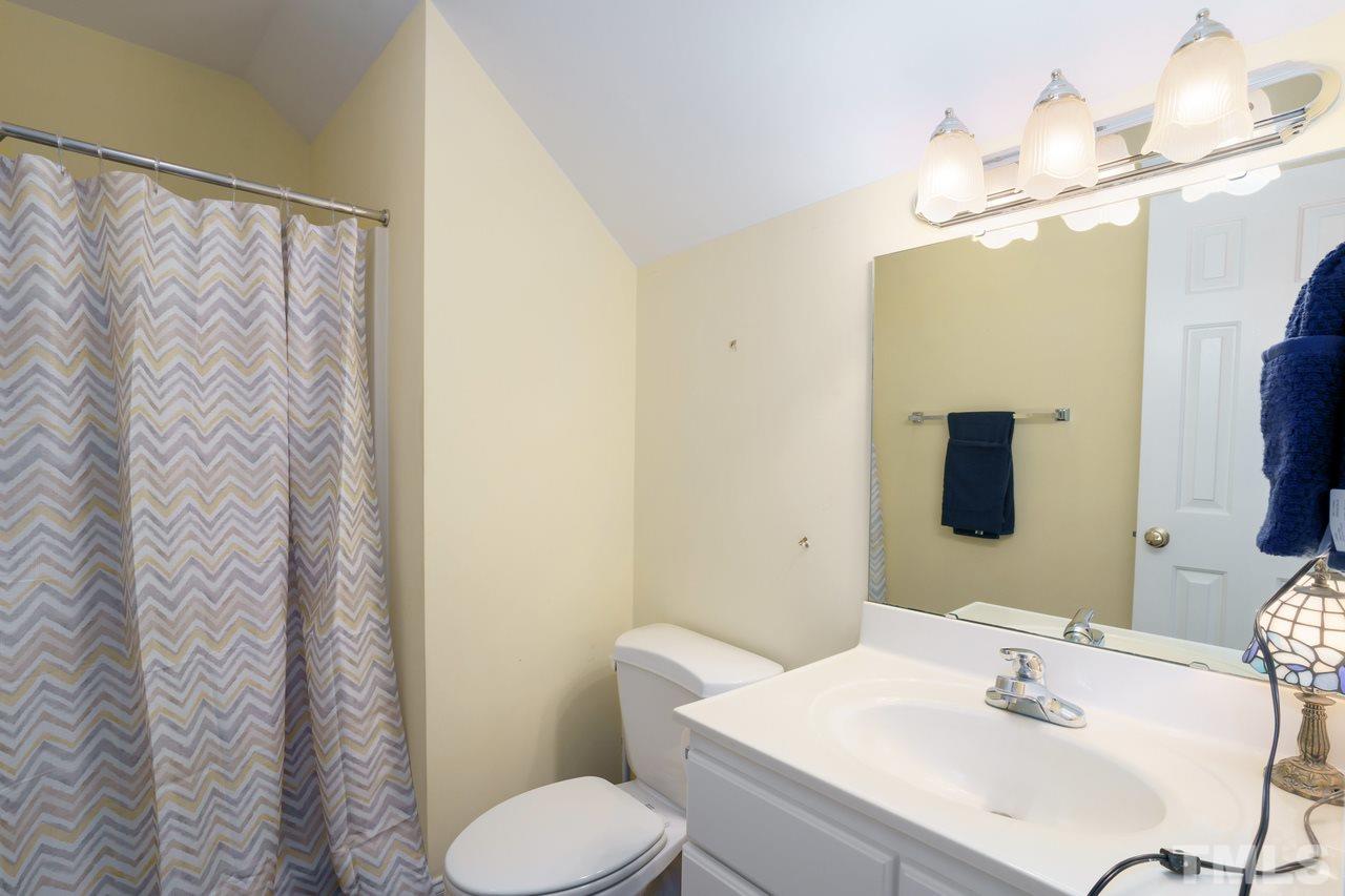 6800 Cool Pond Road Raleigh, NC 27613 - Photo 22 of 26 a bathroom with a sink vanity mirror and toilet